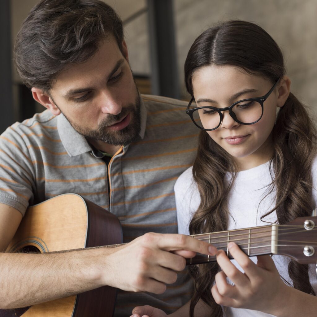 Kid learning to play guitar chords