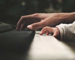 A baby's hand on a piano
Description automatically generated