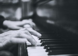 A person playing a piano
Description automatically generated